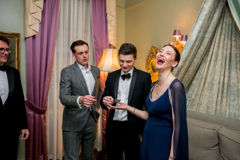 Party Magician Brendan Patricks entertains a small group with amazement.