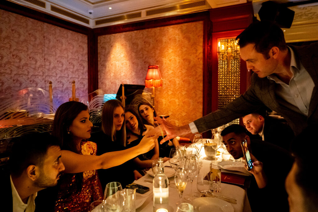 close-up magician performing at luxury London dinner party